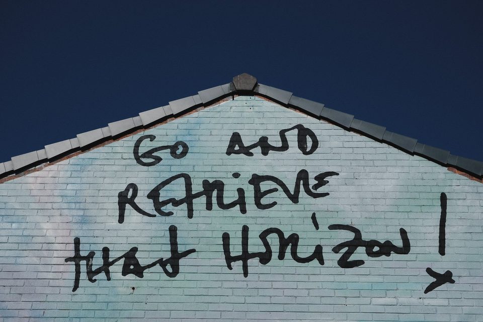 Go and retrieve that horizon! painted in black handwritten capitals across the top of the Black Pearl mural